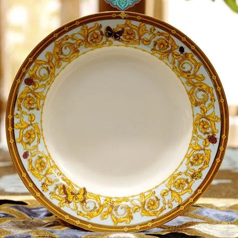 Golden butterfly dinnerware set by MC THE BLACK DIAMOND featuring elegant tableware with butterfly designs on plates and bowls.
