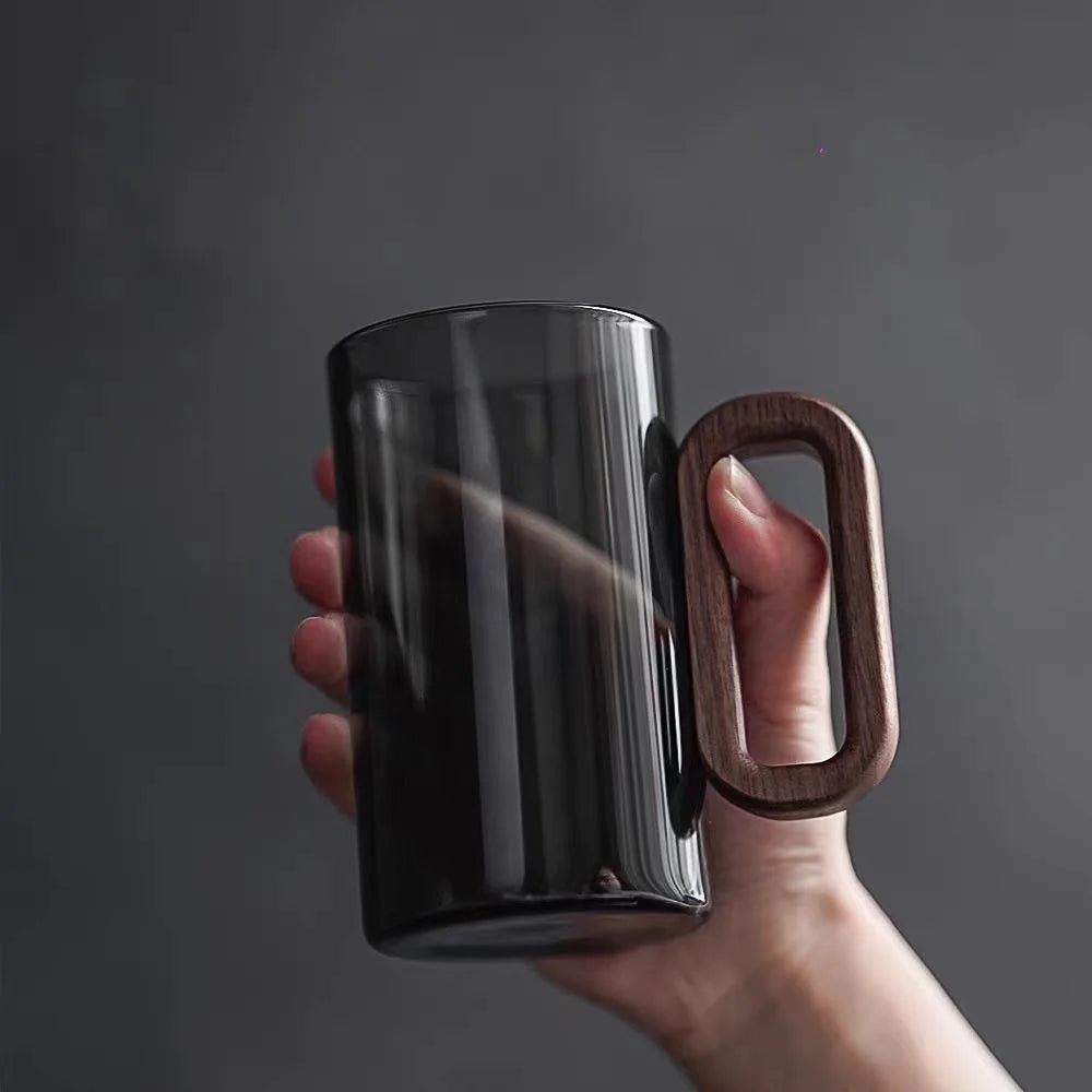 Glass mug with wooden handle from MC The Black Diamond drinkware set, perfect for hot beverages, showcasing a clear glass design.