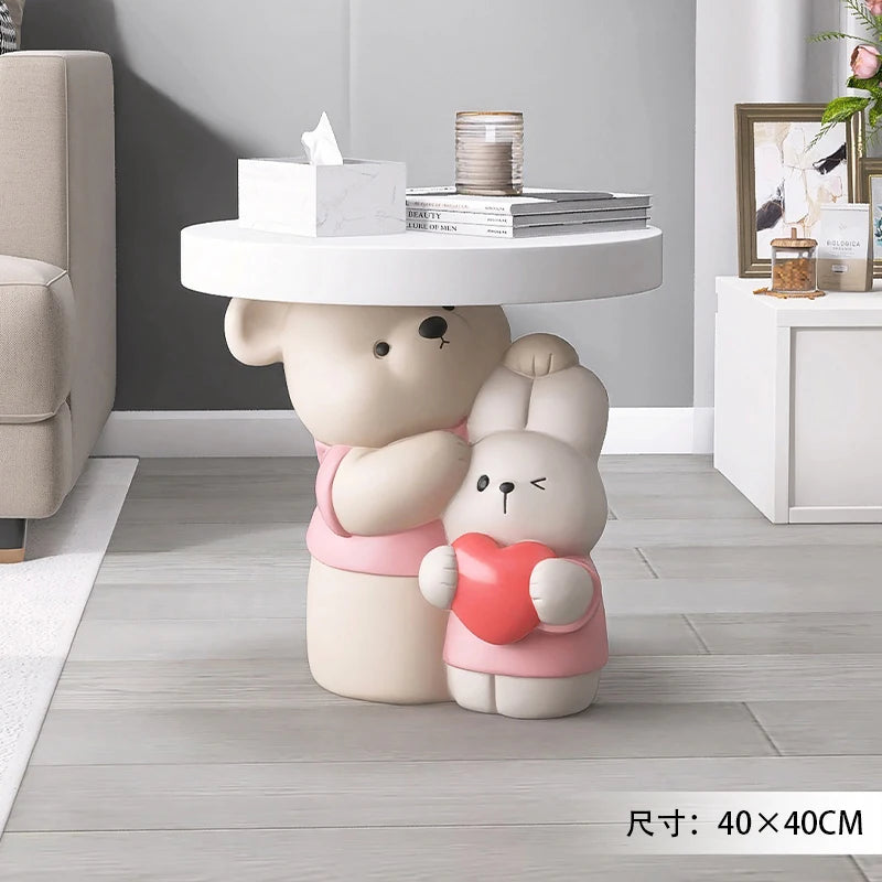 Cream-colored parent-child bear sculpture on a coffee table by MC THE BLACK DIAMOND, perfect as a home decor accent.