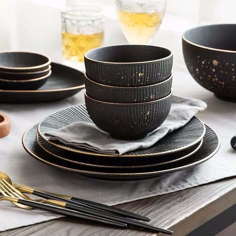 Luxury Golden Black MC THE BLACK DIAMOND dinnerware set with elegant plates and bowls, perfect for sophisticated table settings.