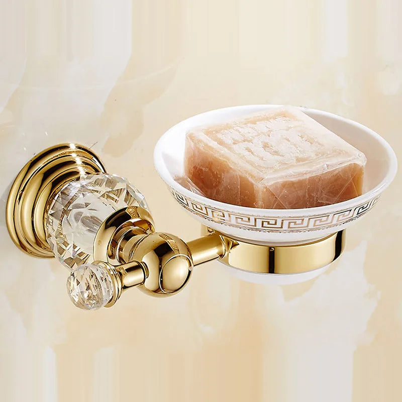 Luxury gold polished brass bathroom accessories set by MC THE BLACK DIAMOND, includes soap dish, toothbrush holder, and tumbler.